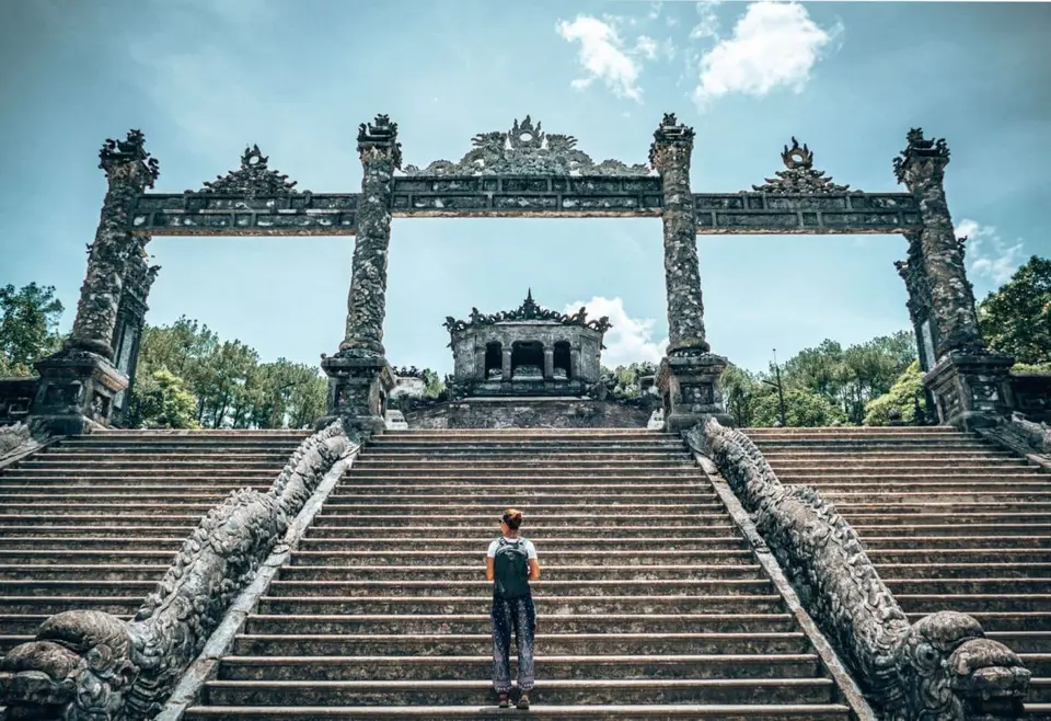 Girl walking up stairs at the Khai Dinh tomb in Hue Vietnam