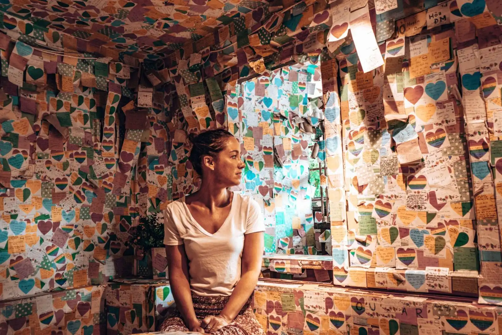 Girl sitting in a cafe full of post-it notes